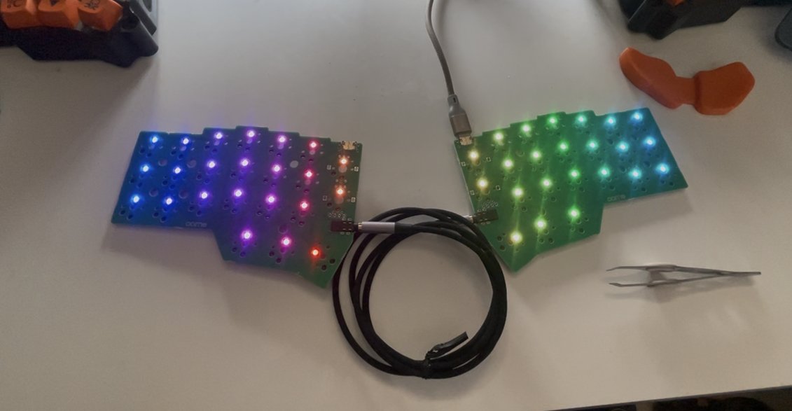 Both Corne PCBs connected together, with their RGB LEDs glowing during the first test after flashing the firmware