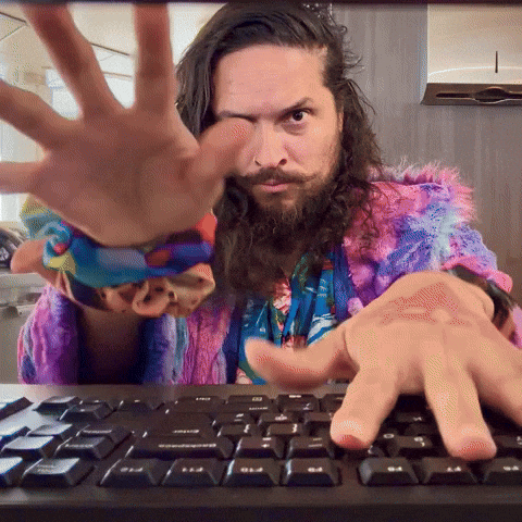 A man enthusiastically typing on a keyboard
